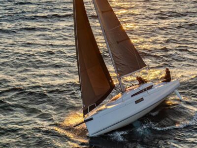 New First 30 brown sails at sunset