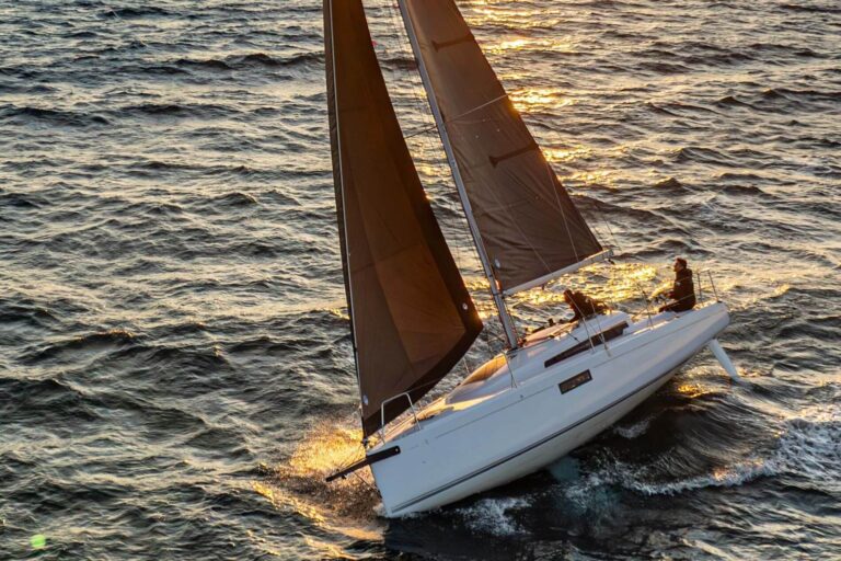 New First 30 brown sails at sunset