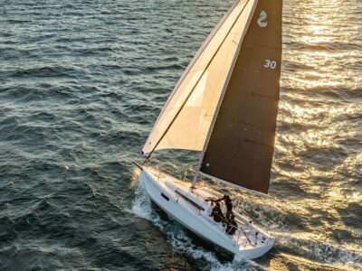 New First 30 sailing with sun on the sails